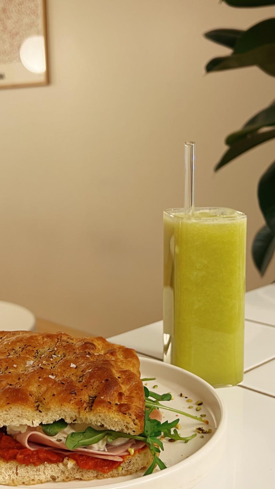 homemade focaccia with fresh cloudy apple juice in tall glass